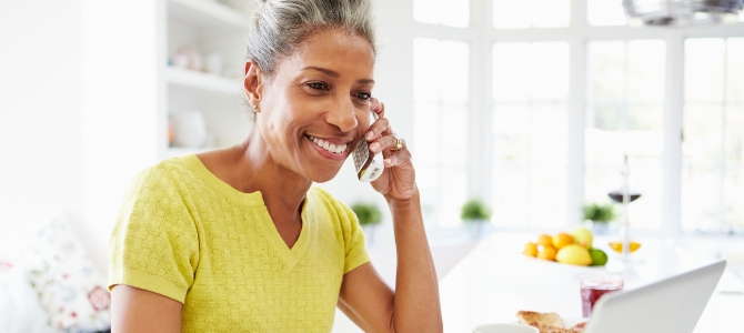 Image of woman speaking on phone with support specialist. 